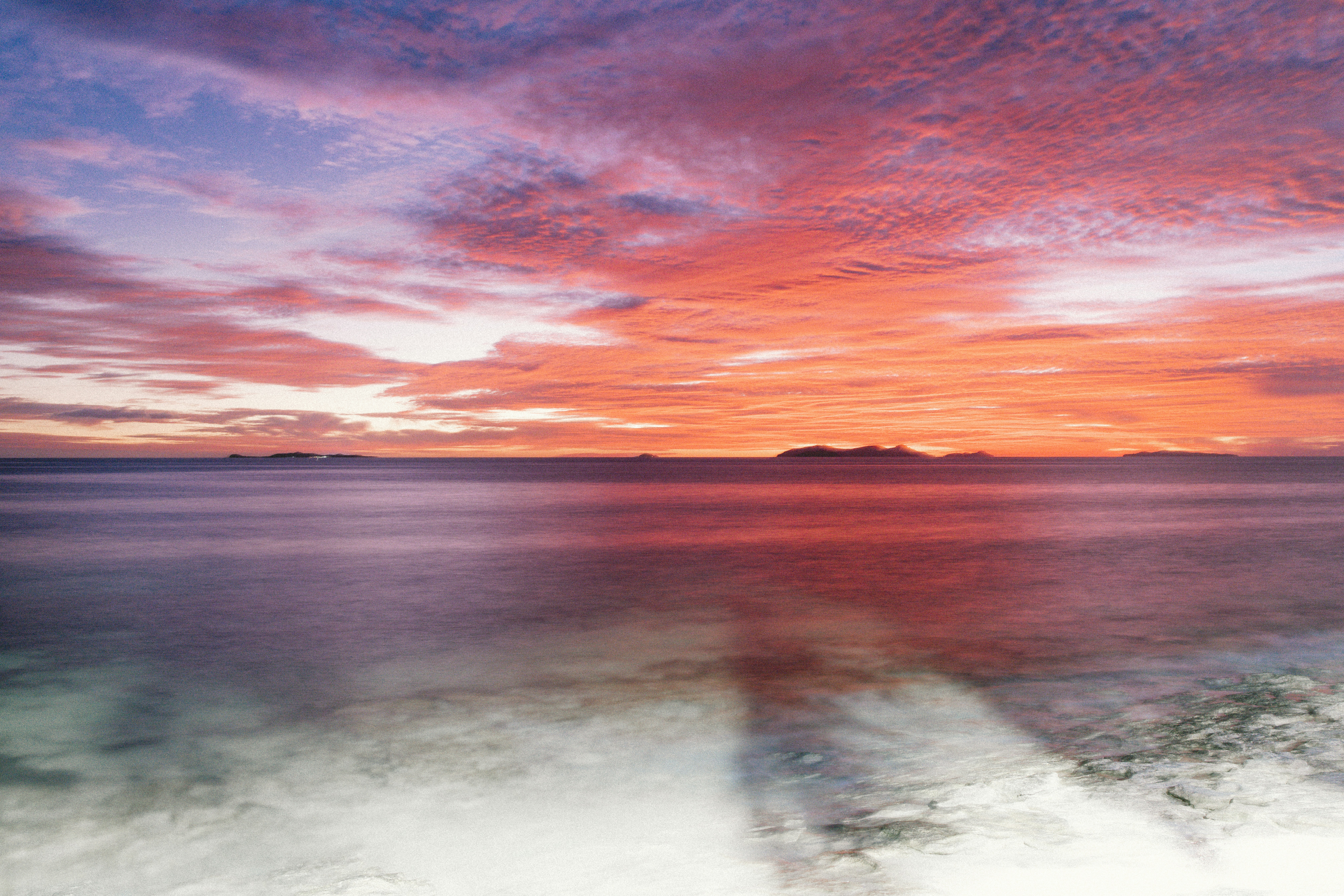 A palm-fringed beach and clear lagoon in Fiji
