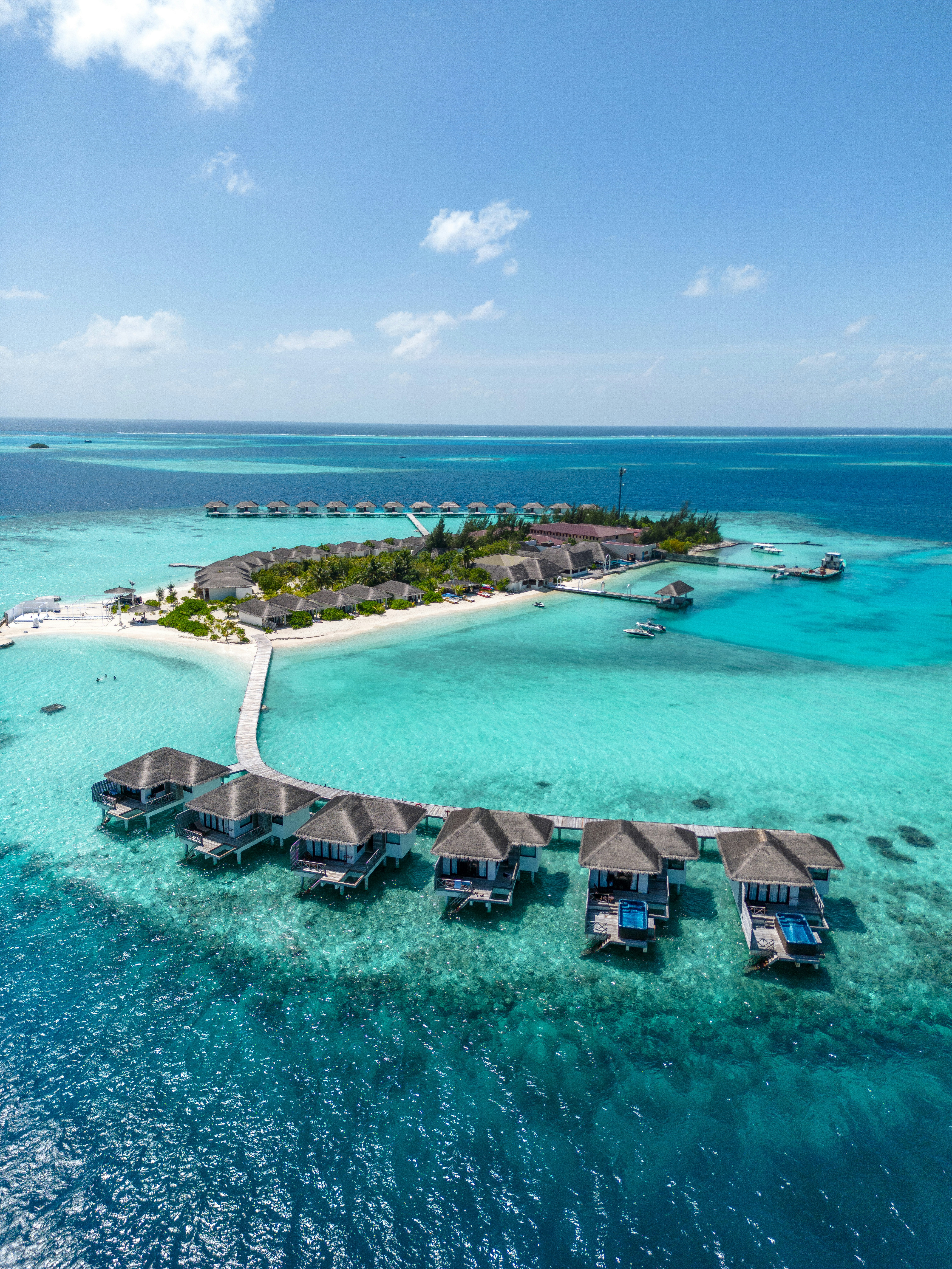 Over-water villas on a turquoise Maldives lagoon
